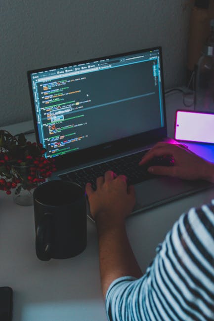 プログラミング学習用のノートパソコンとコードが映る画面